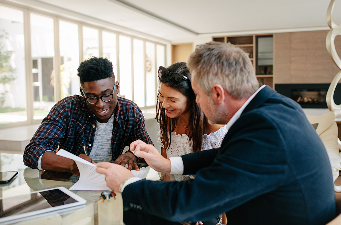 real-estate-document-signing-sitting-at-table