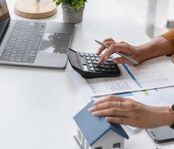 A woman making calculations at a desk.