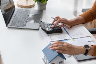 A woman making calculations at a desk.