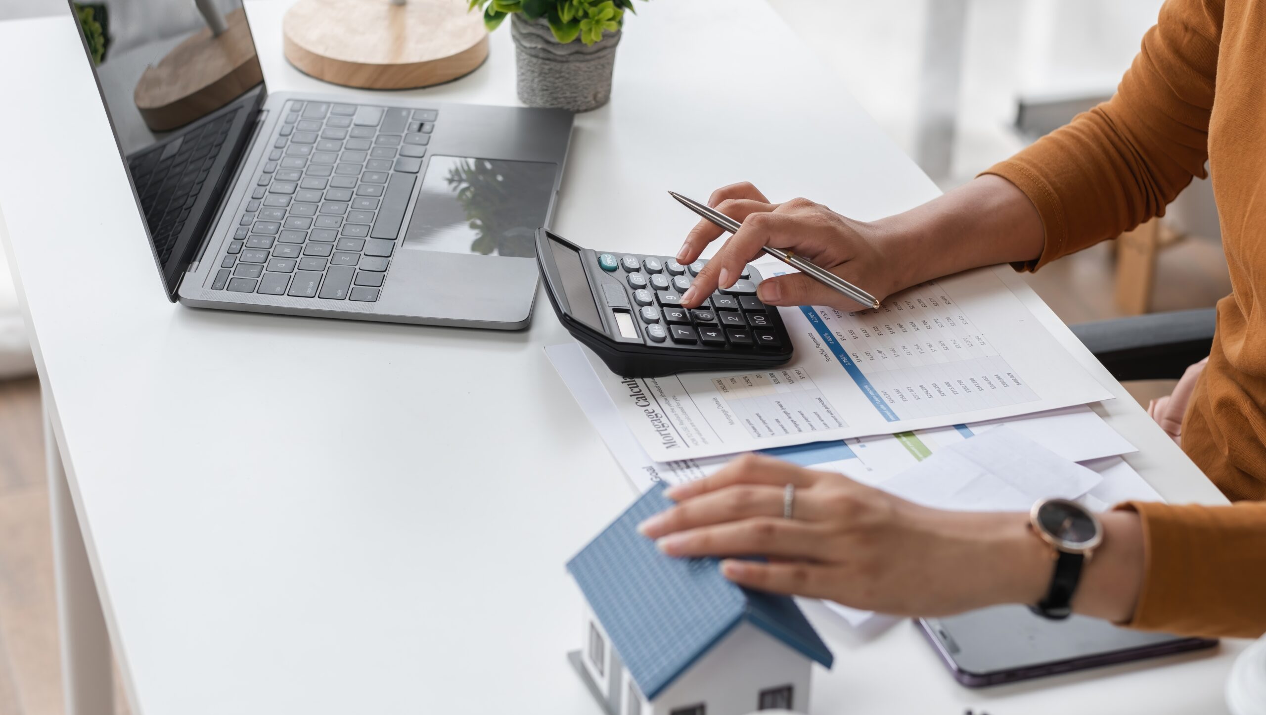 A woman making calculations at a desk.